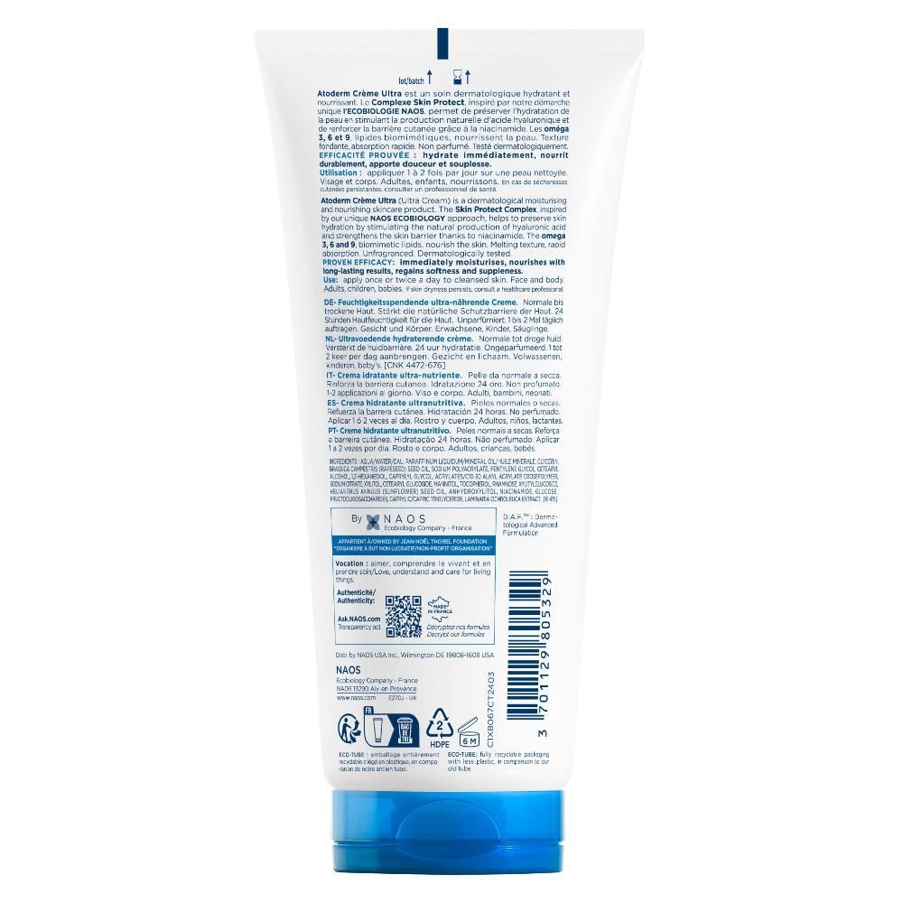 Achterkant van een witte tube met blauwe dop. Tekst in meerdere talen. QR-code en recyclingsymbolen.