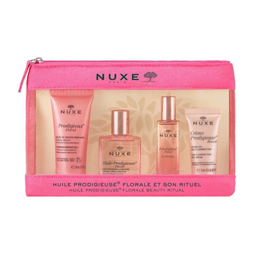 Trousse rose contenant quatre produits Nuxe. Comprend des tubes et flacons avec noms de produits et logo. Texte : Huile Prodigieuse Florale et Son Rituel.