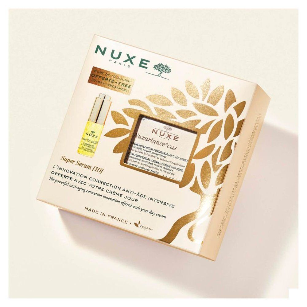 Geschenkset Nuxe Nuxuriance Gold. Beige verpakking met serum en crème. Tekst: Nuxe, Nuxuriance Gold, Super Serum [10].