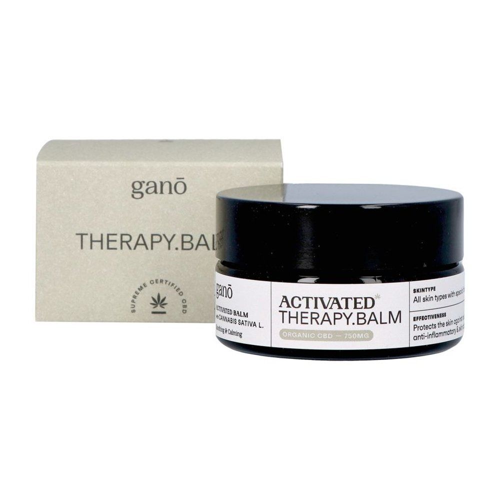 Pot en verre noir avec couvercle noir et boîte. Inscription: Ganō, Therapy Balm, Activated, CBD. Logo de certification.