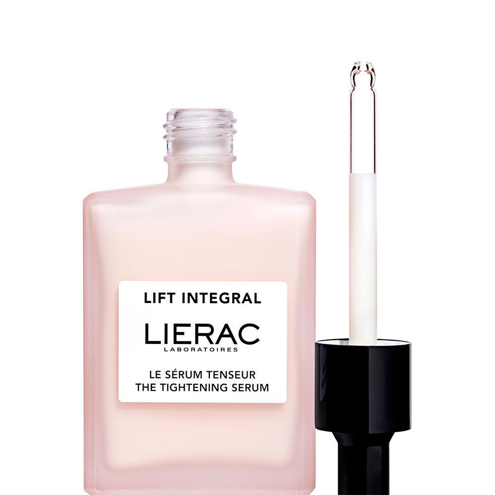 Flacon de sérum rose avec compte-gouttes noir. Compte-gouttes ouvert.
