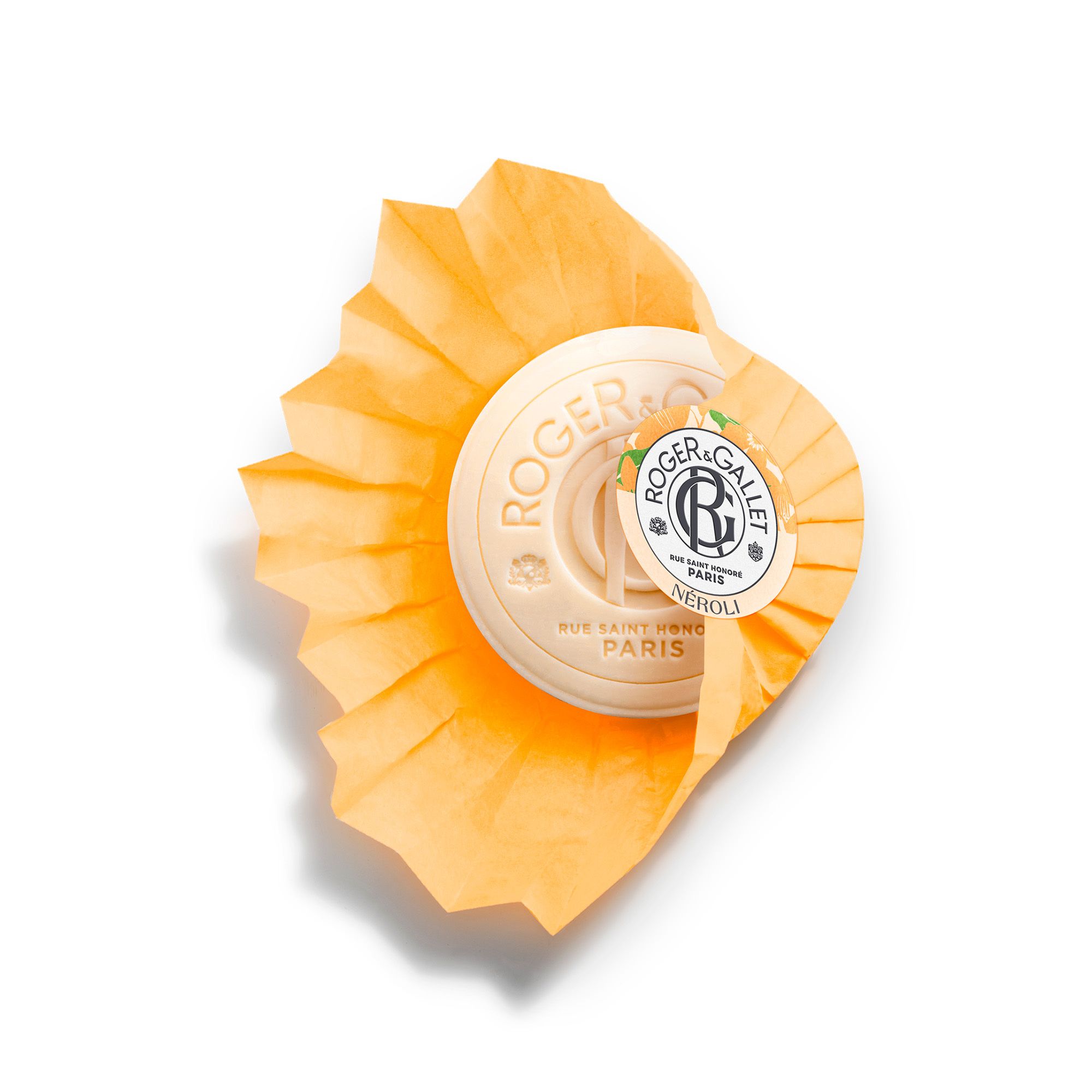 Ronde, oranje zeep met papier. Merk Roger & Gallet, Neroli. Bovenaanzicht.