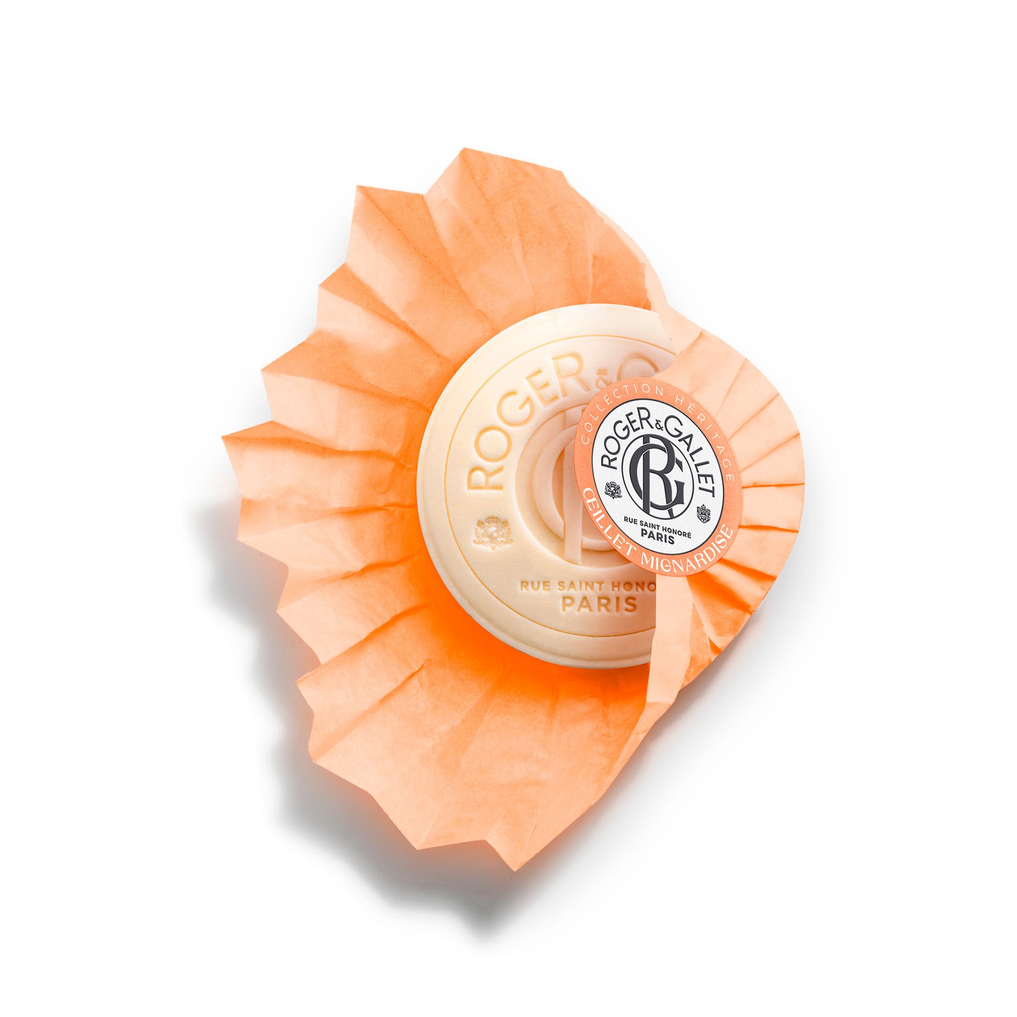 Ronde, oranje zeep met logo. Zeep verpakt in oranje papier. Tekst: Roger & Gallet.