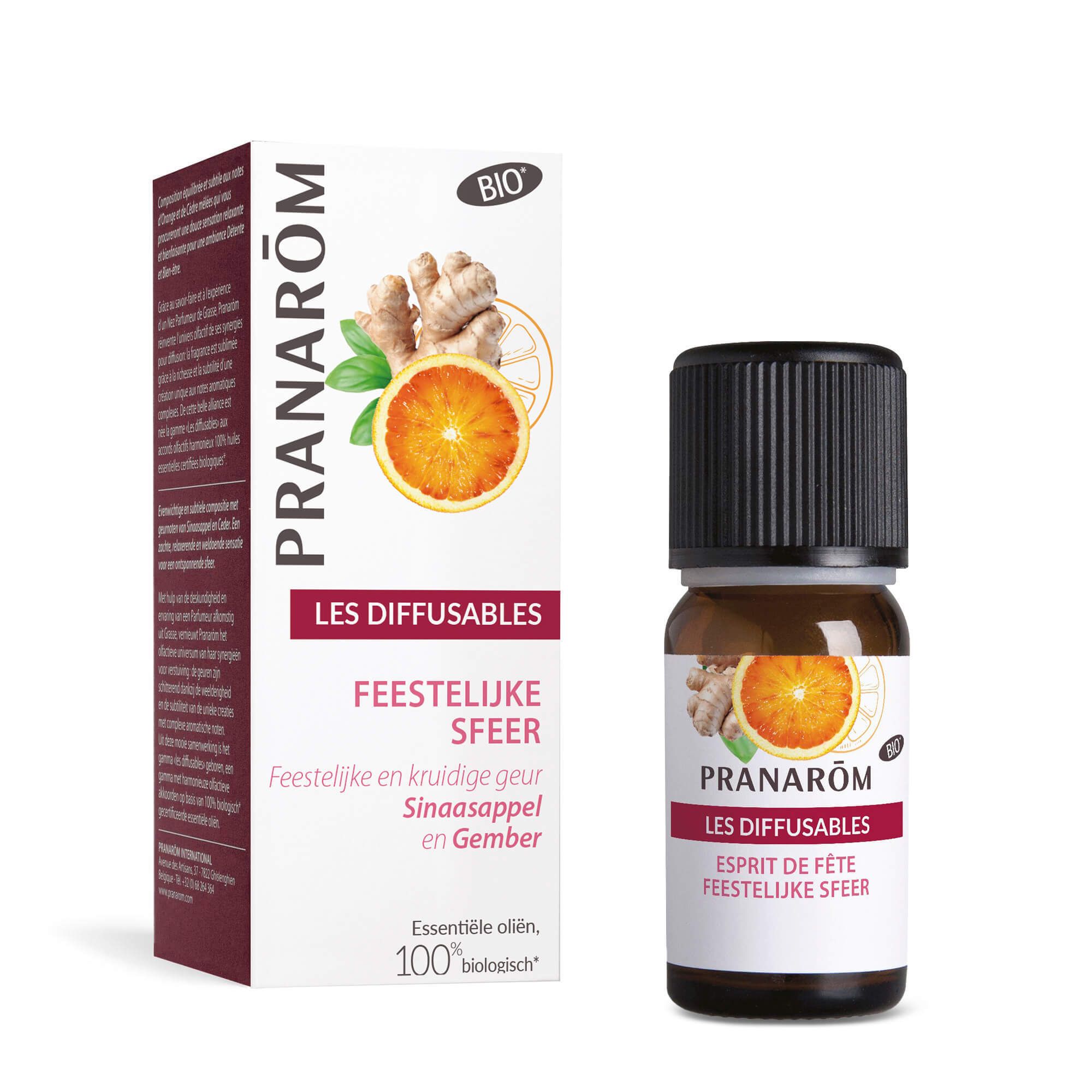 Bruine glazen fles en doos. Opschrift: PRANAROM, LES DIFFUSABLES, FEESTELIJKE SFEER. Illustratie van sinaasappel en gember. BIO-certificering.