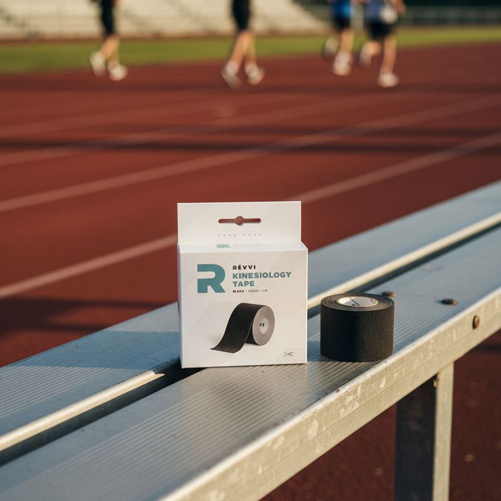 Emballage et rouleau de ruban de kinésiologie sur un banc. Coureurs en arrière-plan.