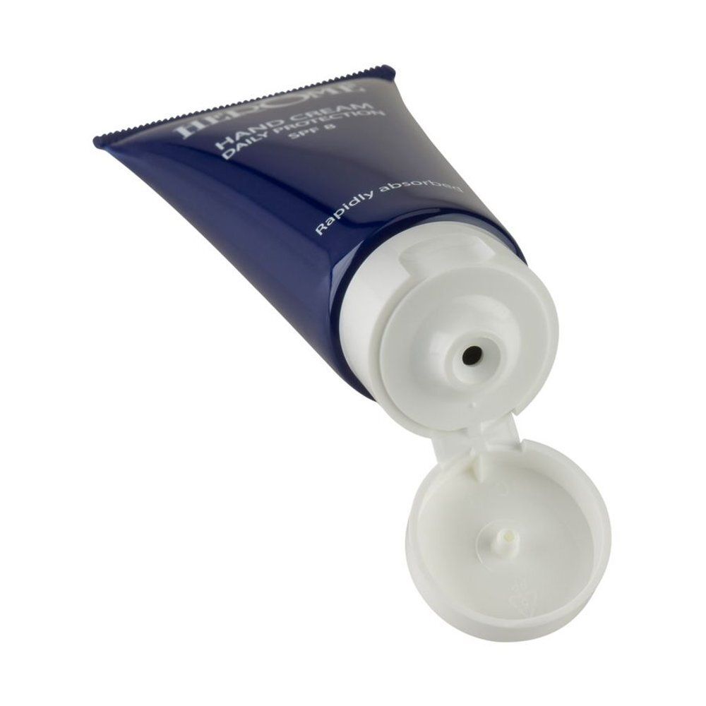 Tube de crème pour les mains bleue ouvert avec bouchon blanc. Inscription : Herome, Hand Cream Daily Protection SPF 8.