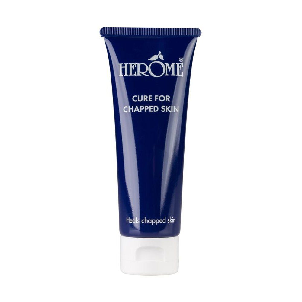 Tube bleu foncé avec bouchon blanc. Inscription: Herome Cure for Chapped Skin. Vue de face du produit.