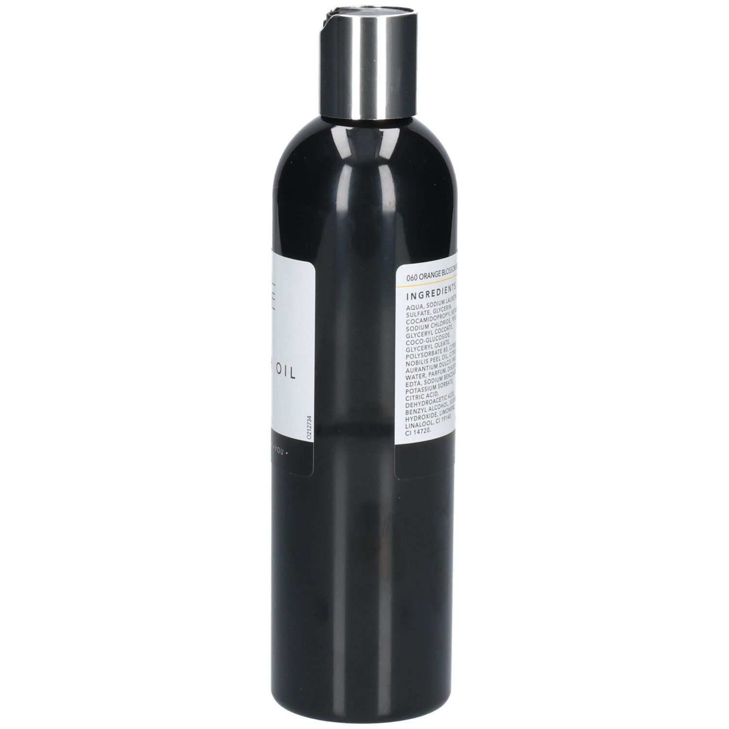 Zwarte fles met zilveren dop. Achterkant met productinformatie. Tekst: "Shower Oil".