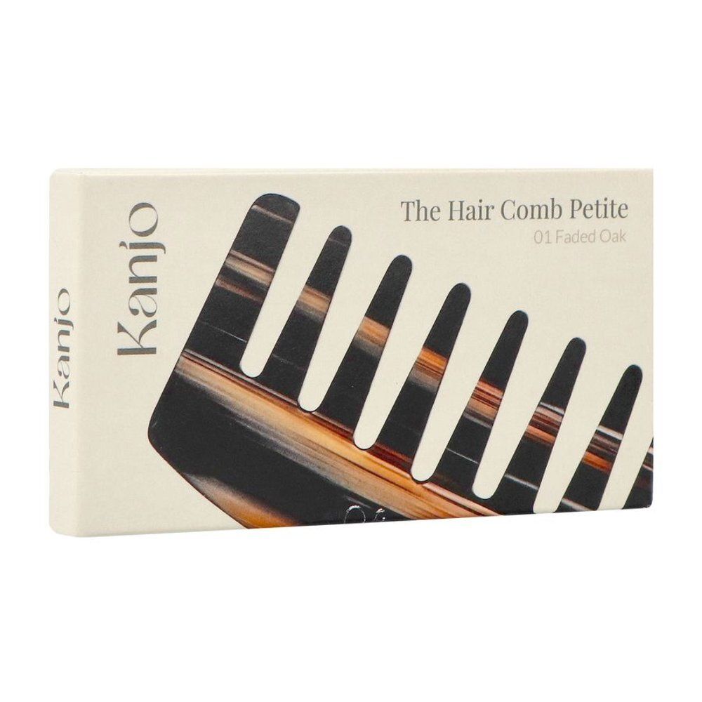 Emballage en carton avec illustration de peigne. Inscription : Kanjo, The Hair Comb Petite 01 Faded Oak.