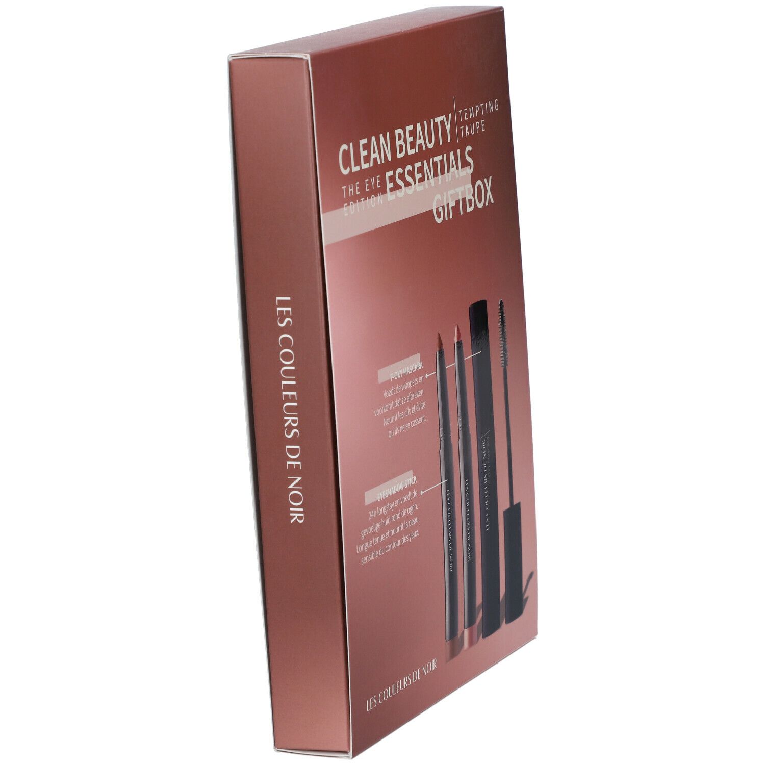Schuinstaande geschenkdoos met cosmetica. Opschrift: LES COULEURS DE NOIR Essentials Giftbox. Bevat mascara, oogpotlood en lippenstift.