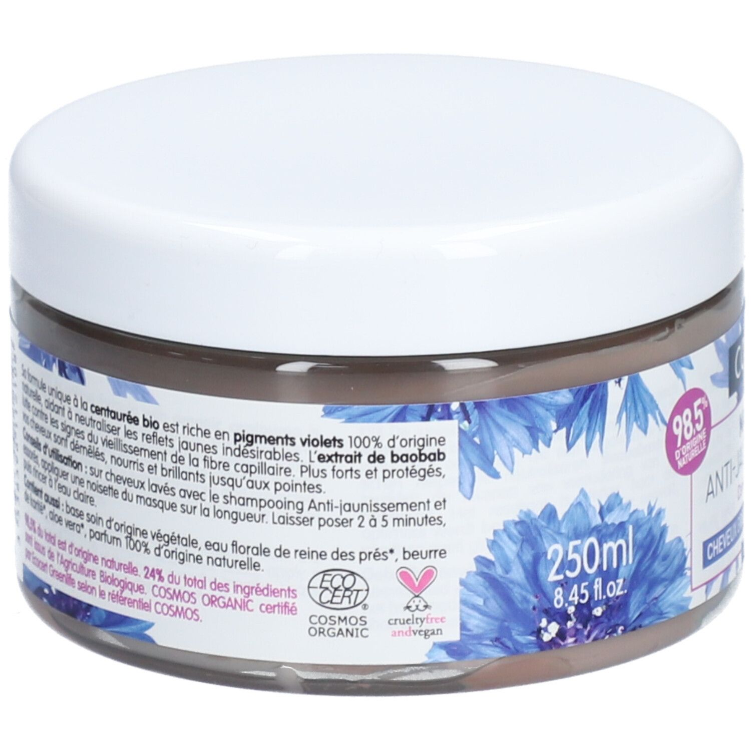 Ronde pot met witte deksel. Opschrift: Coslys Masque Anti-Jaunissement. Blauwe bloemmotieven. 250ml. Franse tekst.