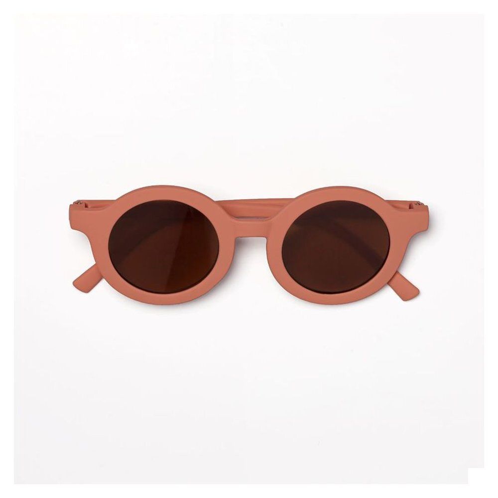 Lunettes de soleil rondes pour enfants, monture rose, verres bruns. Vue de dessus.