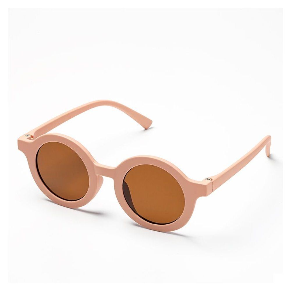 Lunettes de soleil pour enfants, monture rose, verres bruns. Vue en perspective.