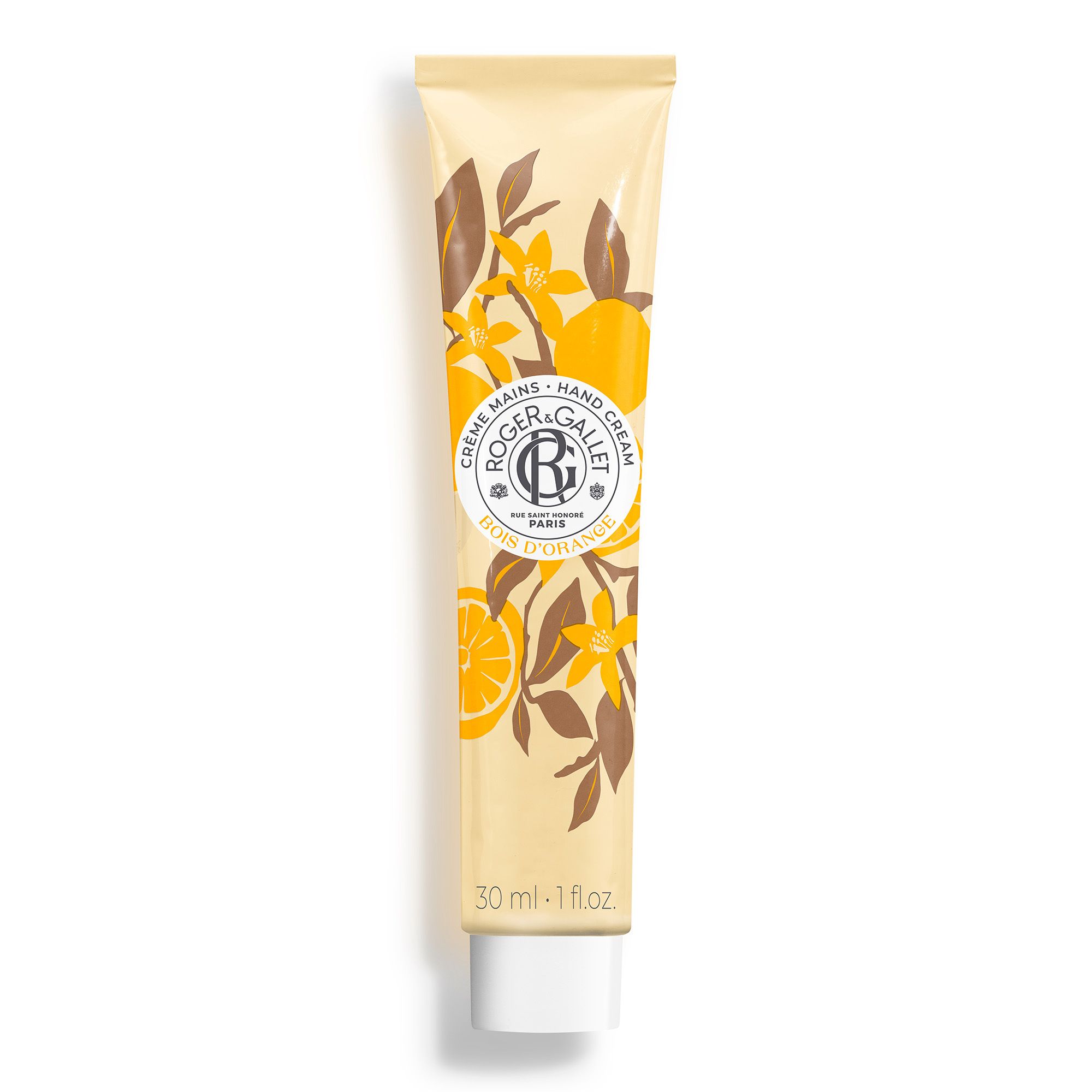 Crèmetube met bloemmotief en productnaam. Opschrift: Crème Mains, Hand Cream, Bois d'Orange. 30 ml.