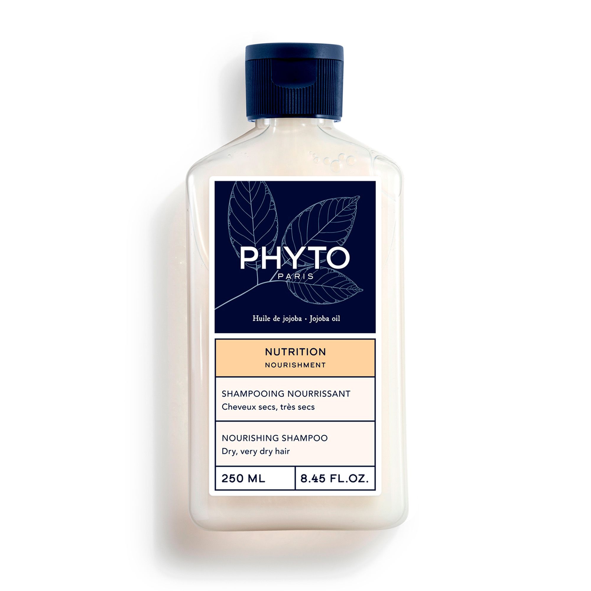Fles PHYTO Nutrition Shampoo. Witachtige vloeistof, donkerblauwe dop. Etiket met logo, productnaam en informatie.