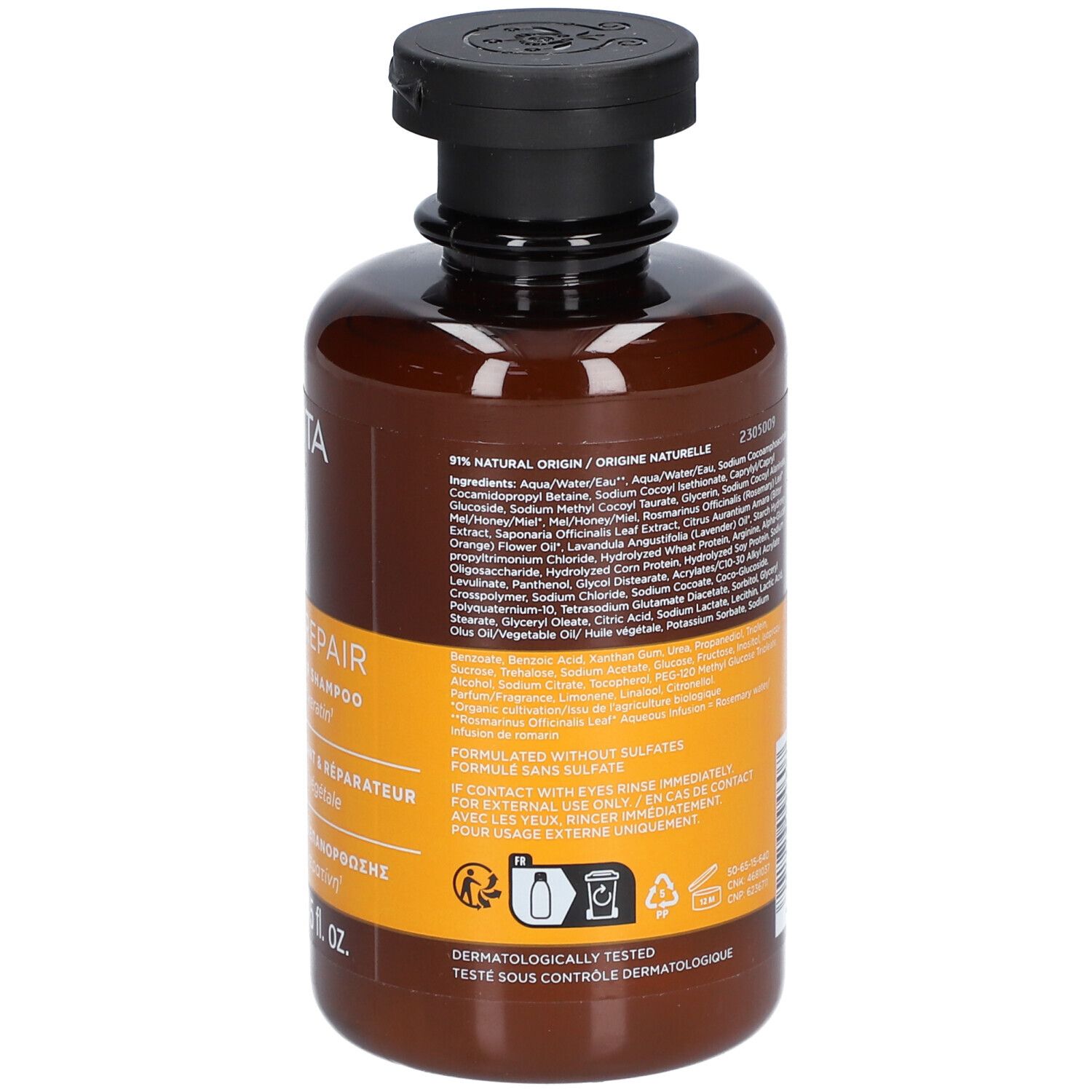 Bruine shampoofles met zwarte dop en etiket met ingrediënten en aanwijzingen.