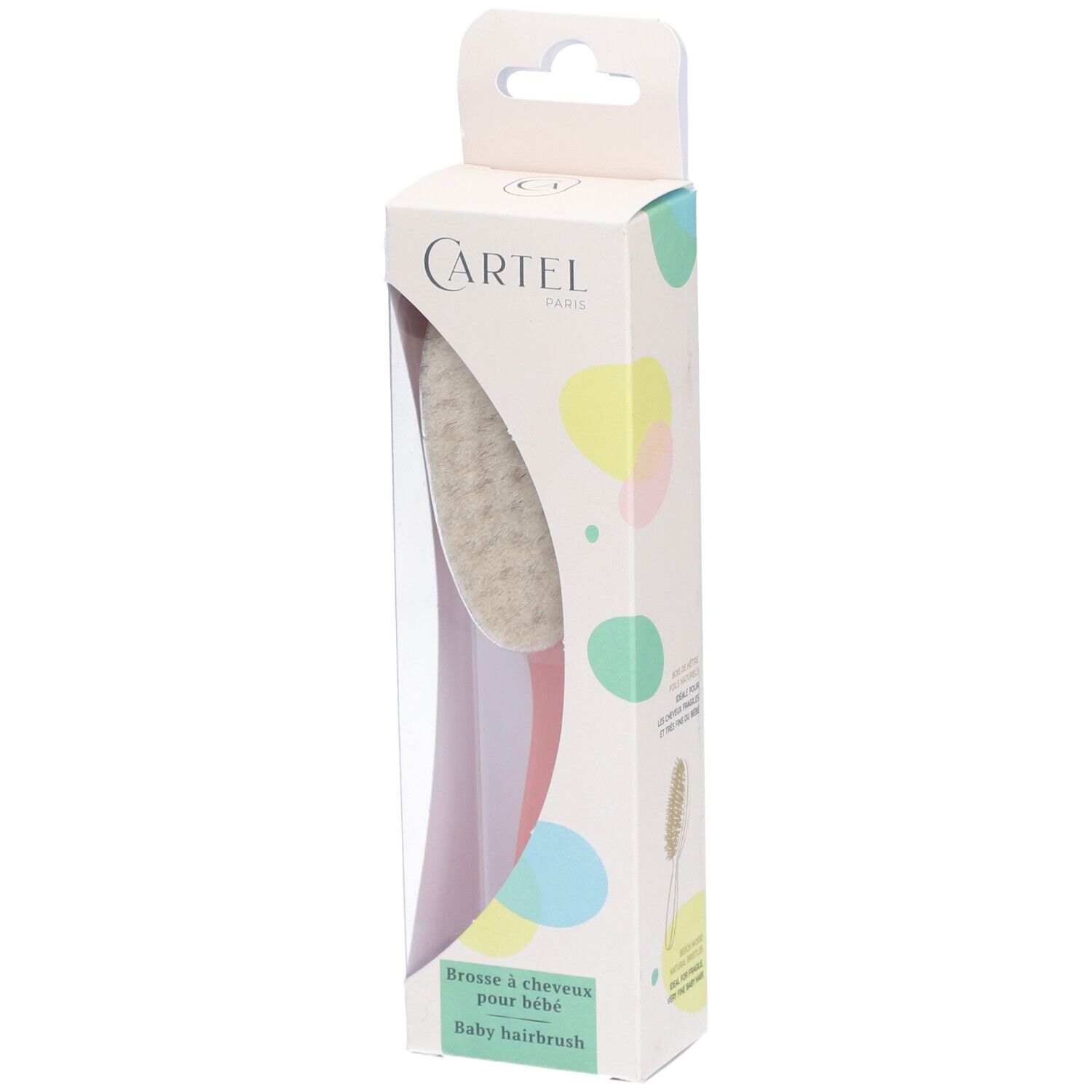 Brosse à cheveux pour bébé dans son emballage. Brosse avec tête en poils clairs et manche rose. Boîte avec logo de la marque.