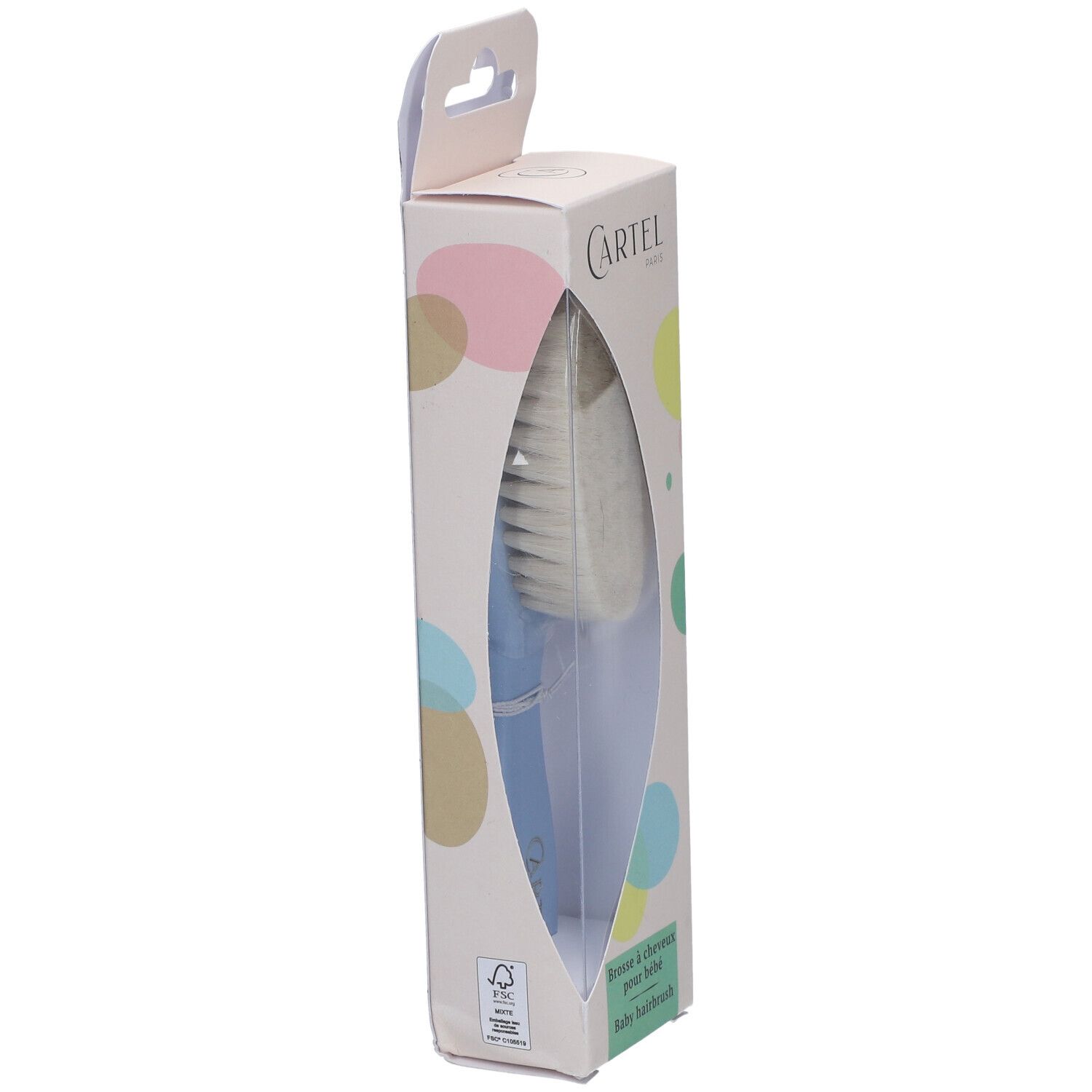 Brosse à cheveux pour bébé dans son emballage. Visible: tête de brosse, manche bleu, marque Cartel Paris. Emballage avec fenêtre.