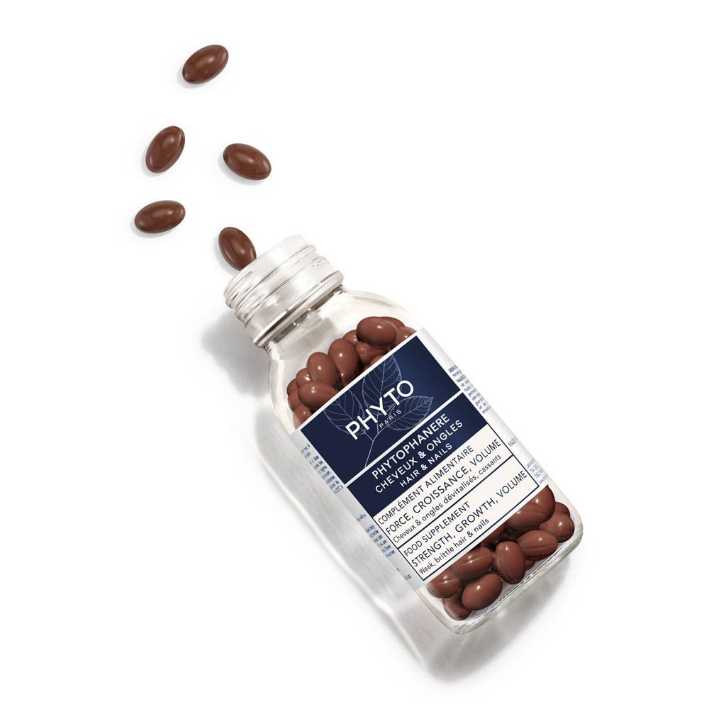 Achterkant van de productverpakking. Tekst en een flesje capsules.