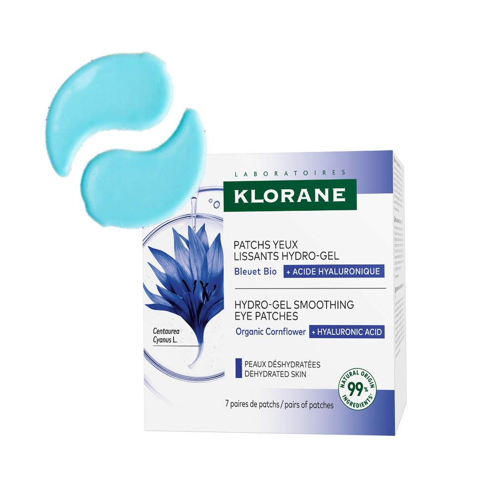 Deux patchs bleus pour les yeux à côté de la boîte Klorane. Emballage du produit avec logo et texte.