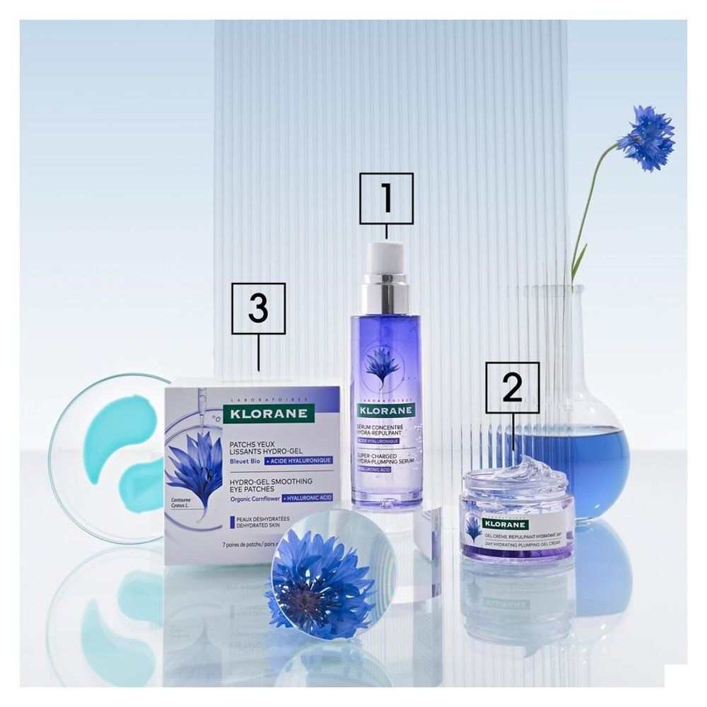 Pot de crème avec couvercle blanc. Inscription : Klorane, Gel Crème Repulpant Hydratant 24H. Illustration de fleur bleue.