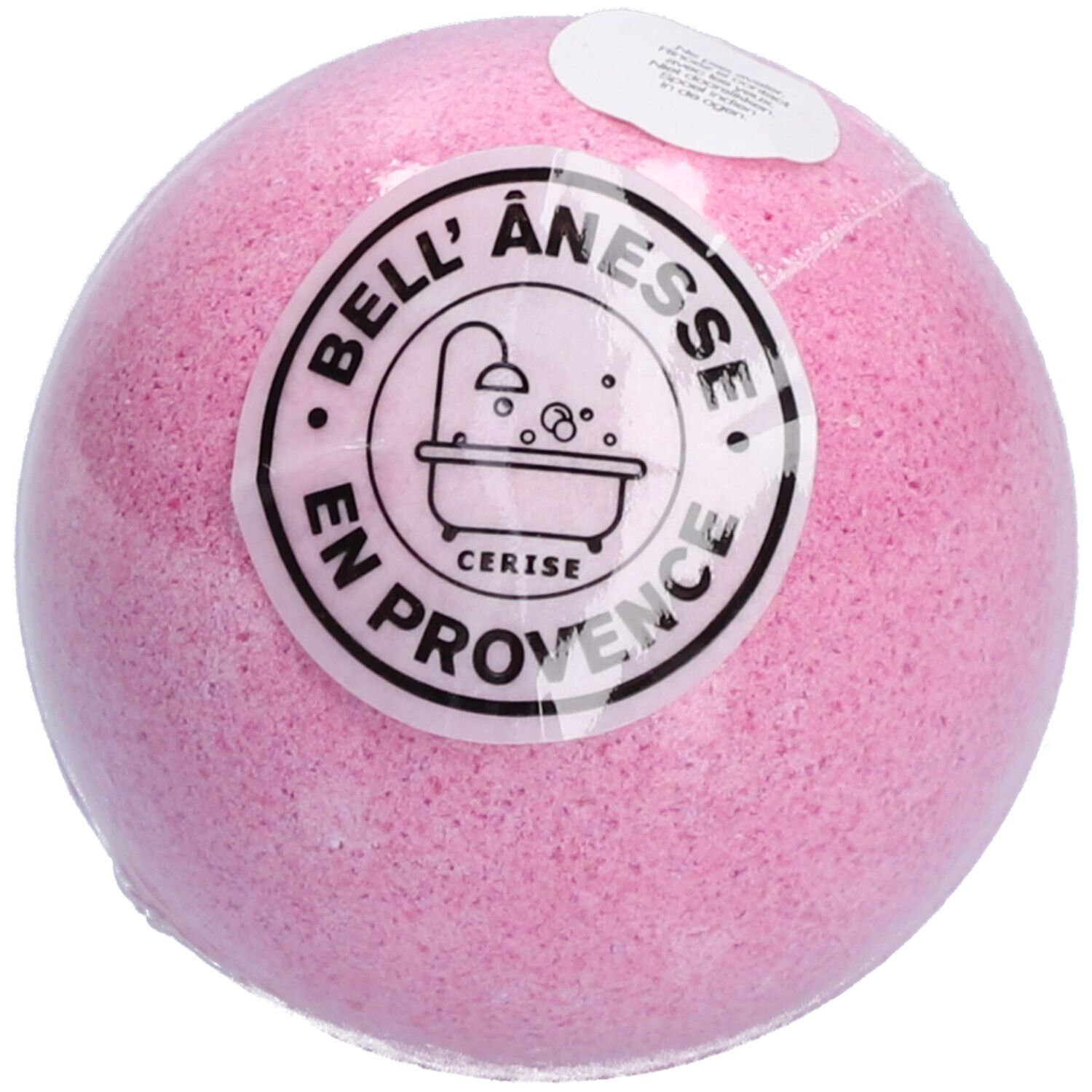 Roze badbruisbal, rond, met sticker. Sticker met tekst: Bell Ânesse, Cerise, en Provence. Product verpakt in folie.