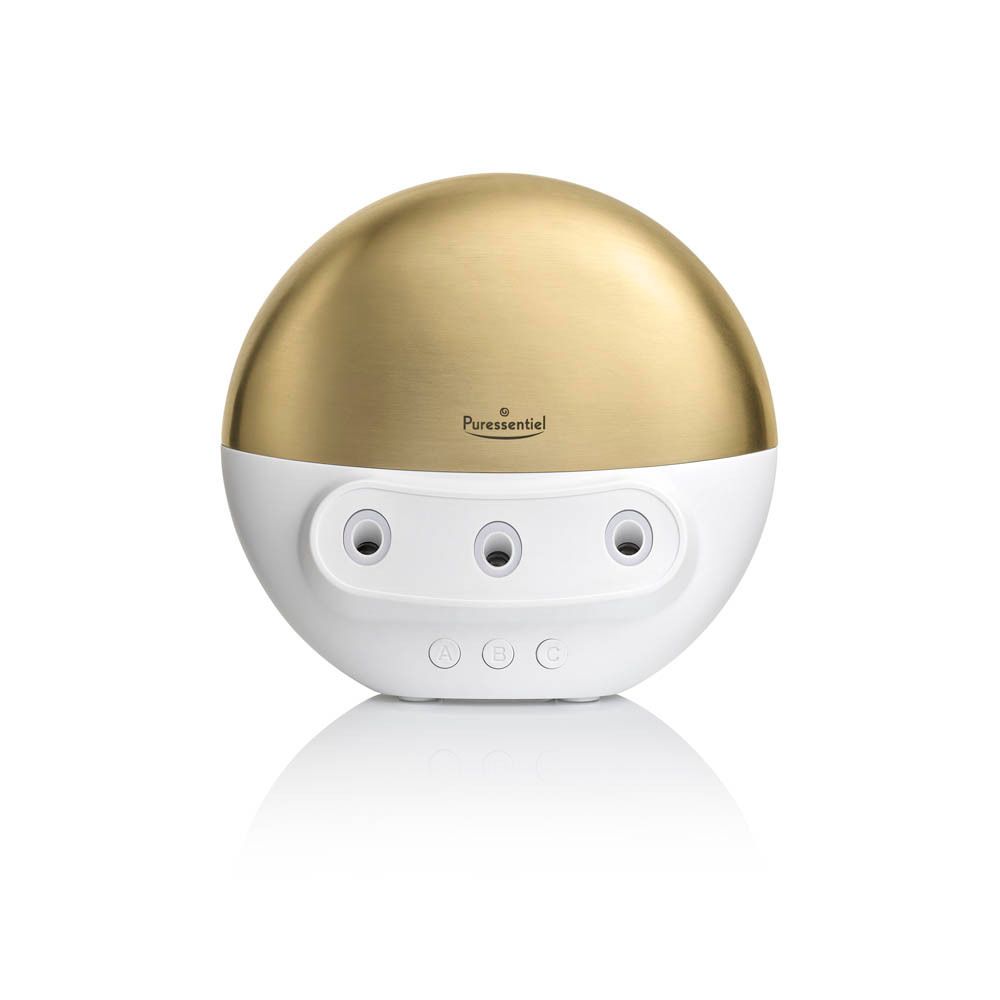 Diffuseur blanc et doré. Forme ronde avec trois ouvertures. Inscription: Puressentiel. Produit pour huiles essentielles.