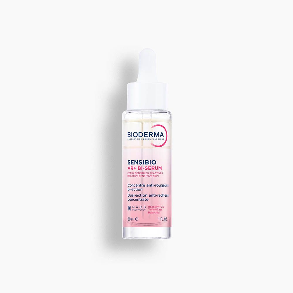 Flacon de Bioderma Sensibio AR+ Bi-Sérum avec pipette. Sérum rose et blanc. Inscription Sensibio AR+ Bi-Sérum.