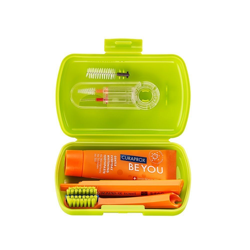 Groene reis set, open. Bevat tandenborstel, tandpasta en tandenragers. Oranje tandpasta.