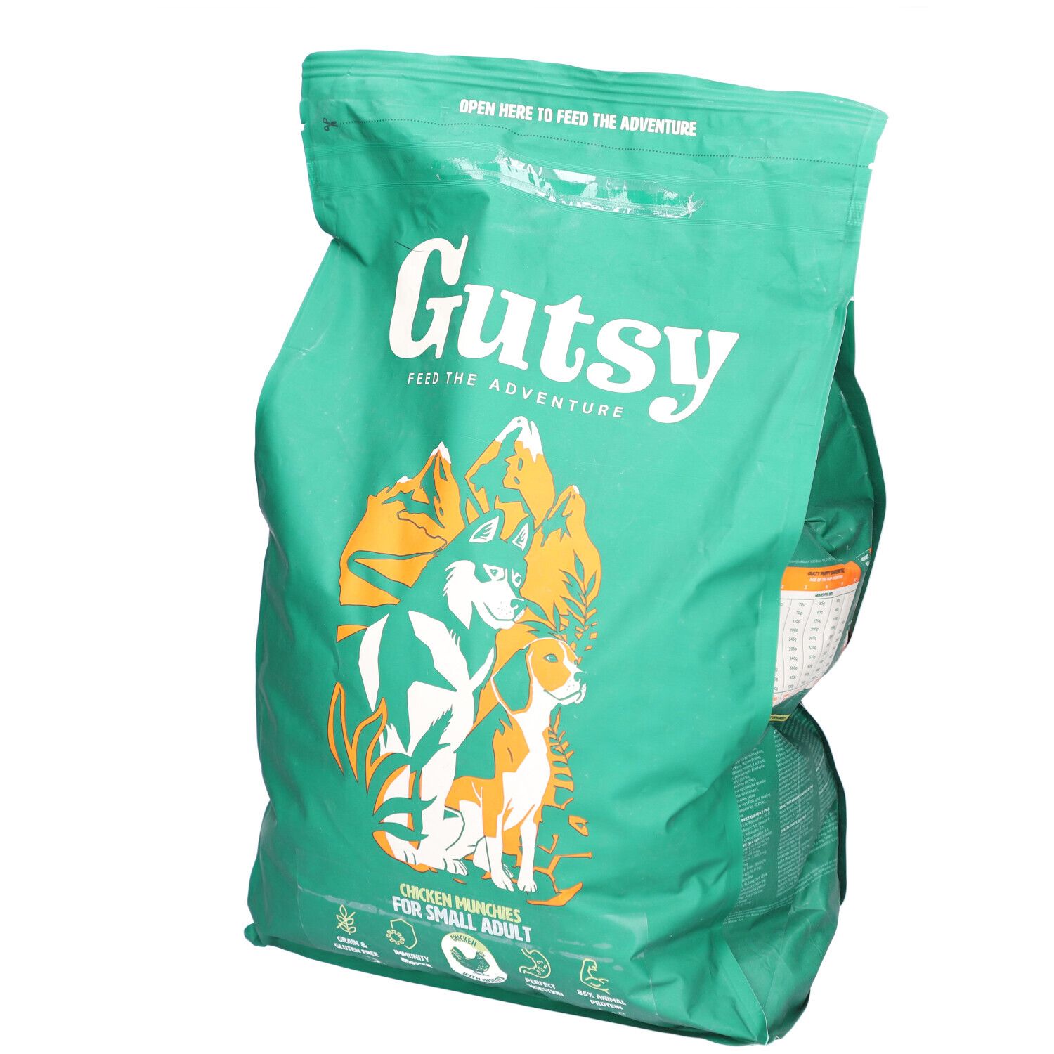 Sac vert avec impression. Contient de la nourriture pour chiens. Inscription : Gutsy, Chicken Munchies pour petits chiens. Illustration de chien et loup.