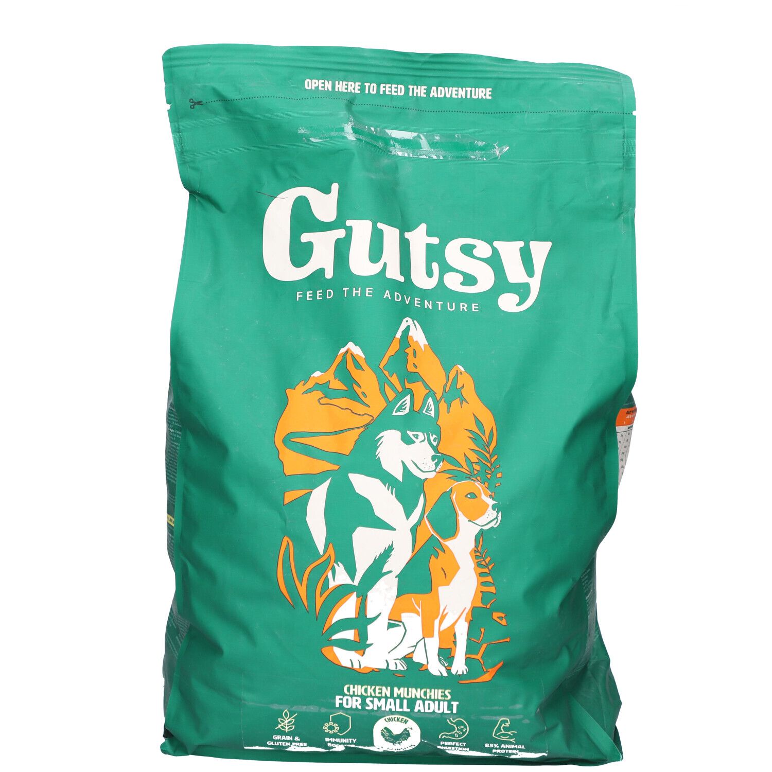 Sac vert avec impression. Contient de la nourriture pour chiens. Inscription : Gutsy, Chicken Munchies pour petits chiens. Illustration de chien et loup.