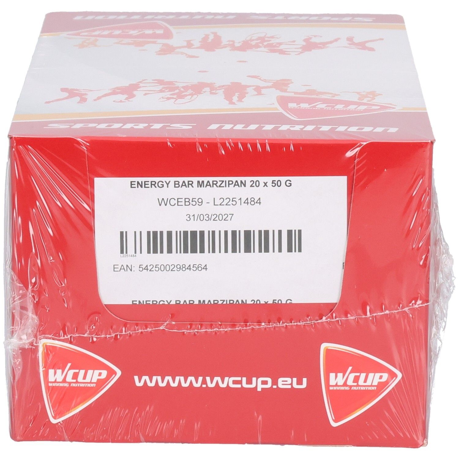Rode kartonnen verpakking, omwikkeld met transparante plastic. Opschriften: ENERGY BAR MARZIPAN 20 x 50 G, Wcup logo, www.wcup.eu en Sports Nutrition.