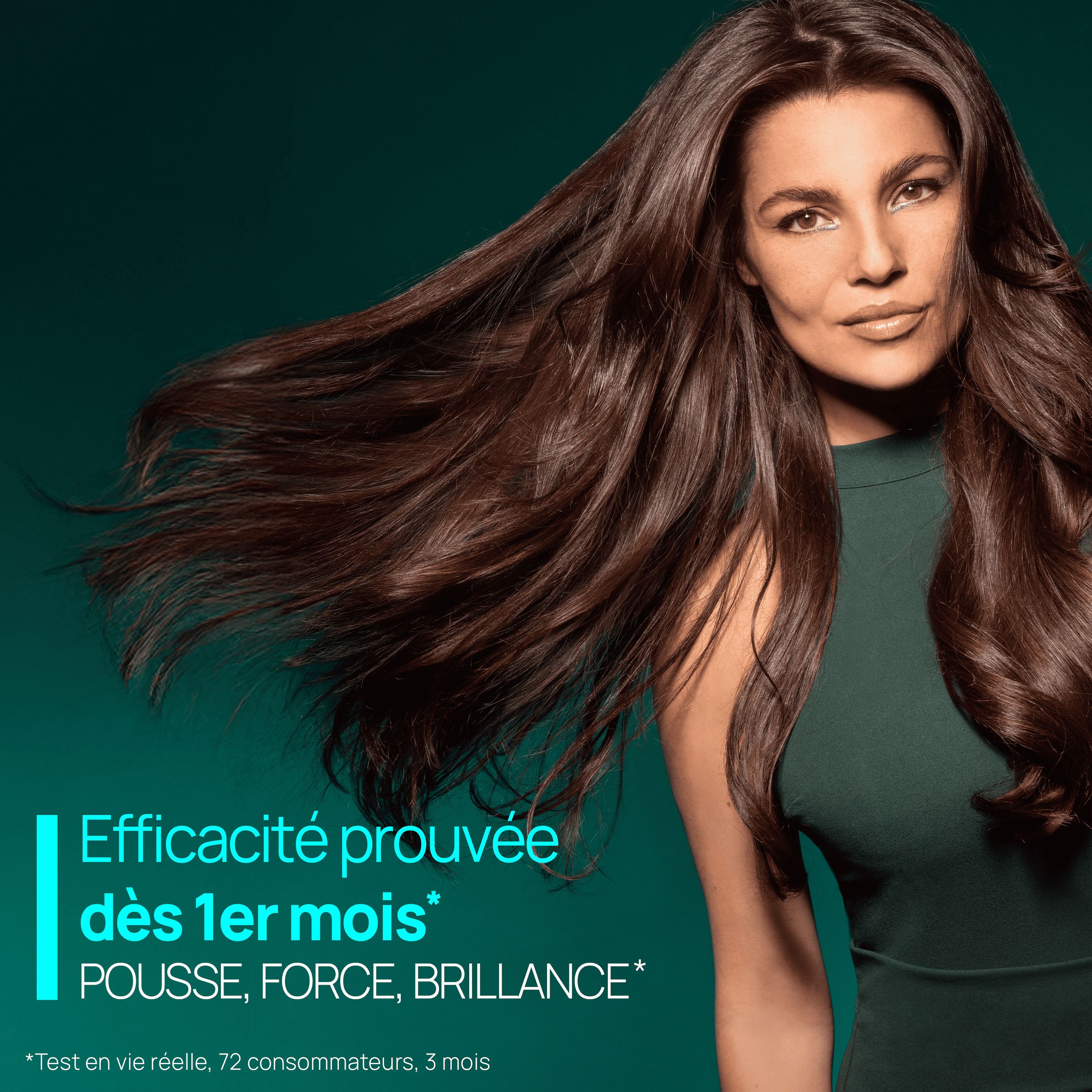 Femme aux longs cheveux bruns. Texte: Efficacité prouvée dès 1er mois. Pousse, force, brillance.