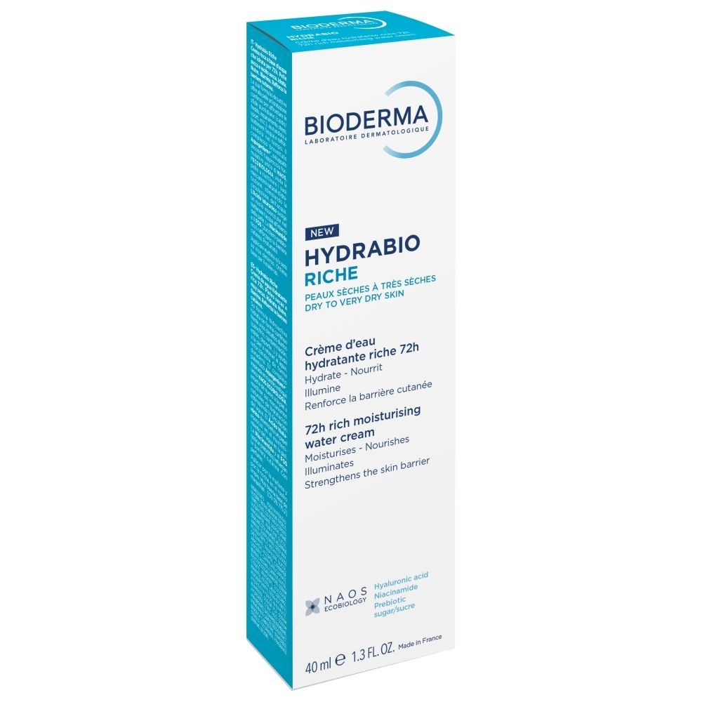 Emballage blanc du produit. Inscription : Bioderma, Hydrabio Riche, Crème d'eau hydratante riche 72h. Fond bleu clair.