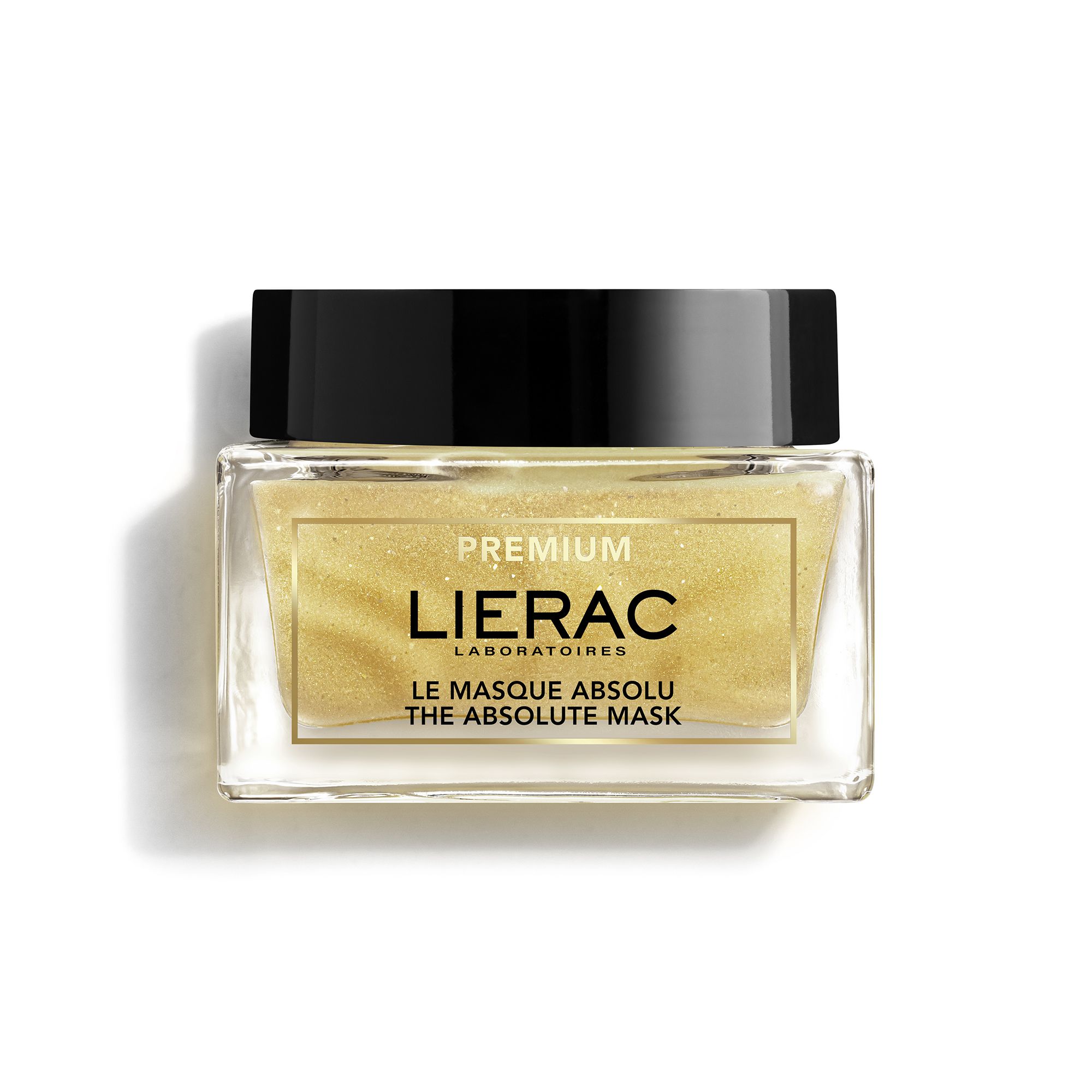 Glazen pot met goudkleurig masker. Opschrift: Lierac, Le Masque Absolu The Absolute Mask. Zwart deksel.