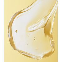 Substance gélifiée sur fond jaune. Liquide avec des bulles.