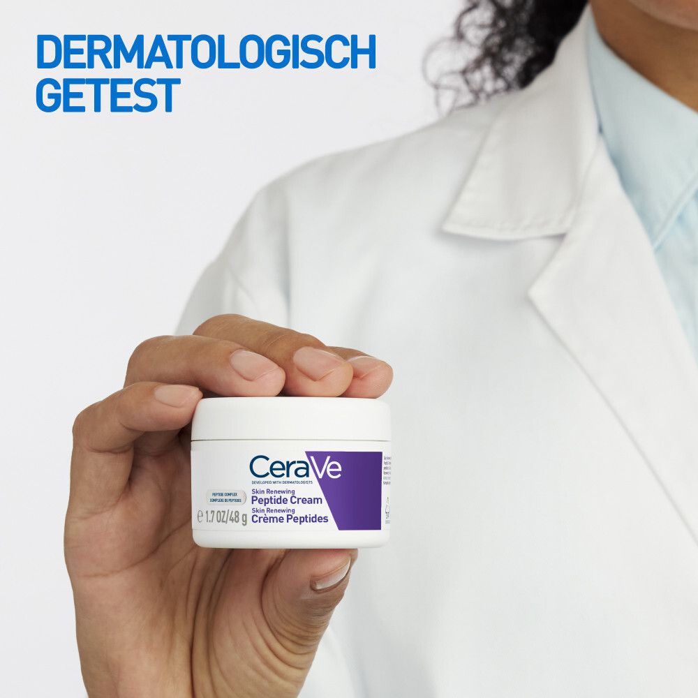 Hand houdt pot crème vast. Tekst: CeraVe Skin Renewing Peptide Cream. Dermatologisch getest.