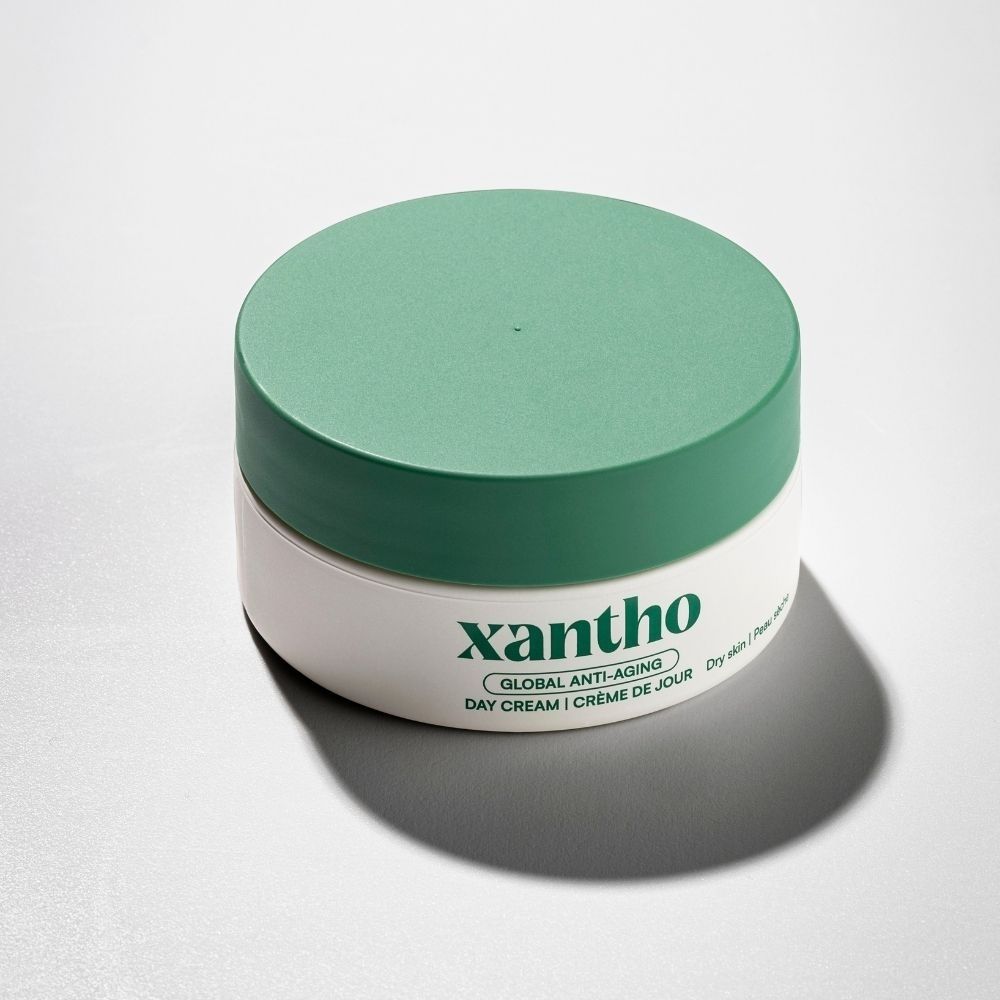Xantho Global Anti-aging dagcrème in witte pot met groene deksel.