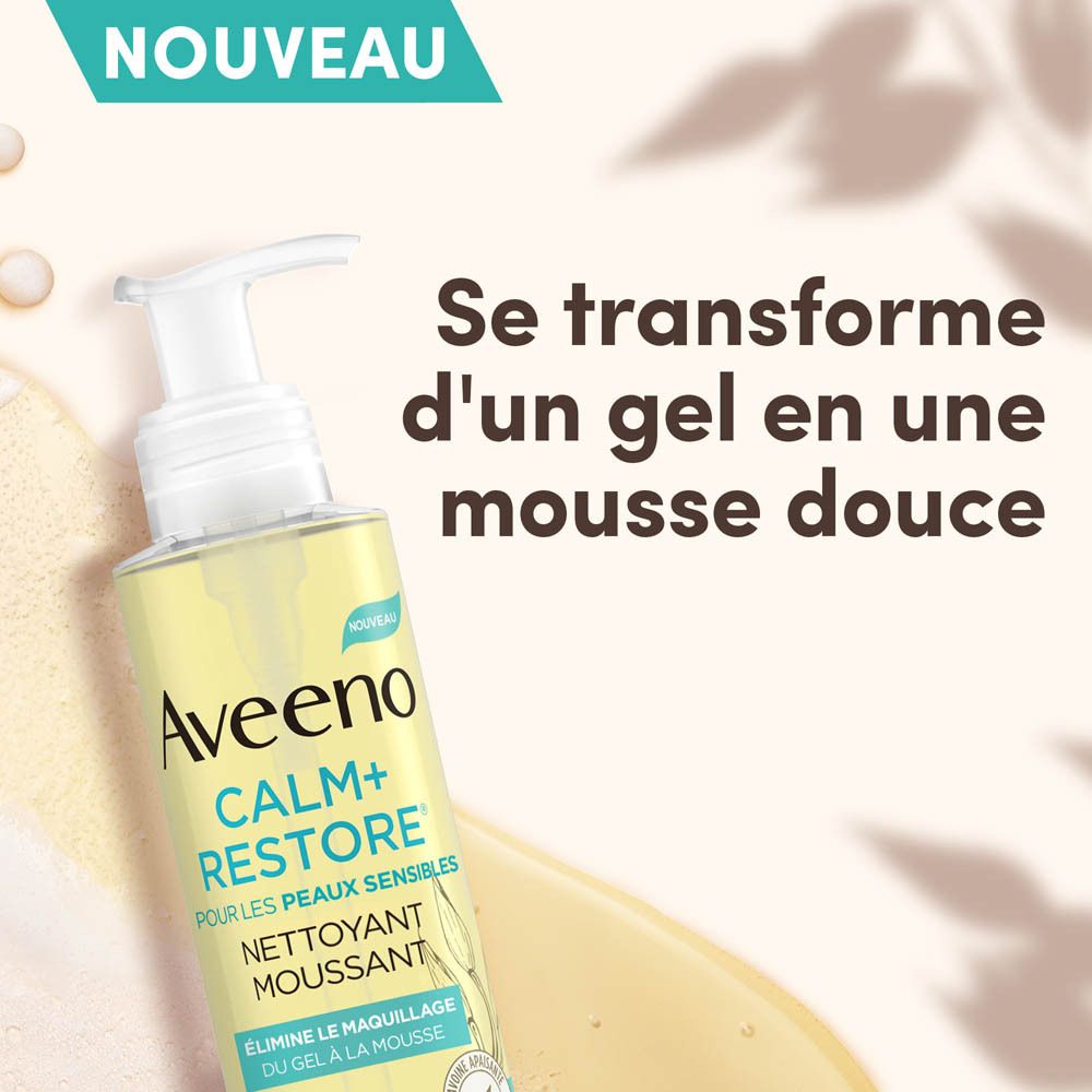 Aveeno Calm+Restore Nettoyant Moussant. Le gel se transforme en mousse. Flacon en arrière-plan.