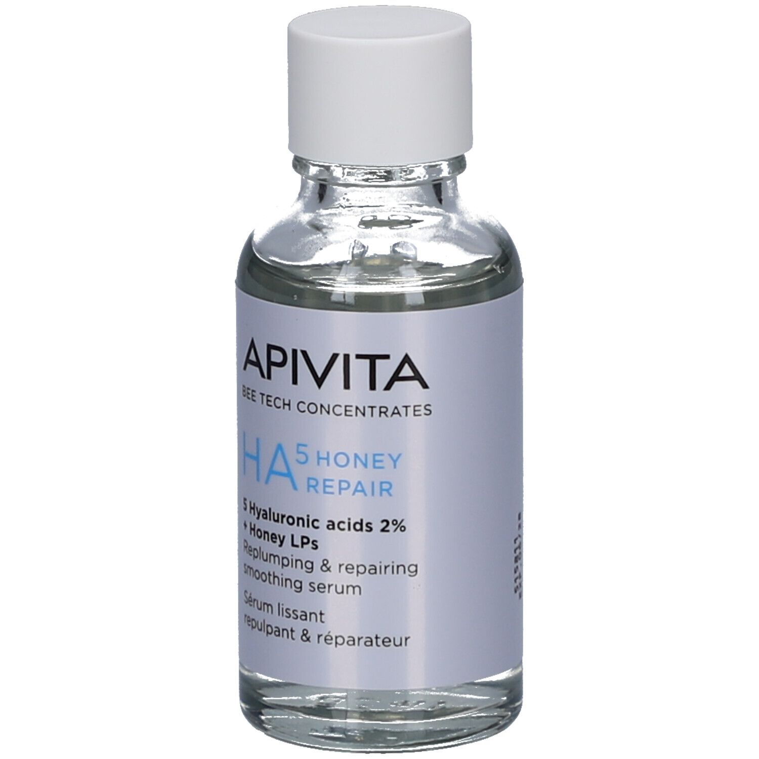 Flacon en verre transparent avec bouchon blanc. Étiquette avec nom du produit, marque Apivita et ingrédients. HA5 Honey Repair Sérum.