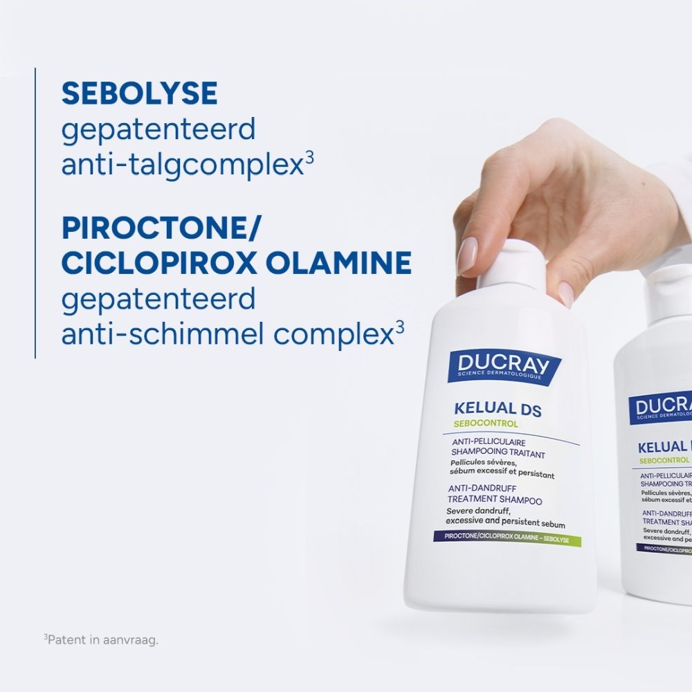 Achterkant van een blauwe spuitbus met witte opdruk en symbolen, waaronder een recycling-symbool.