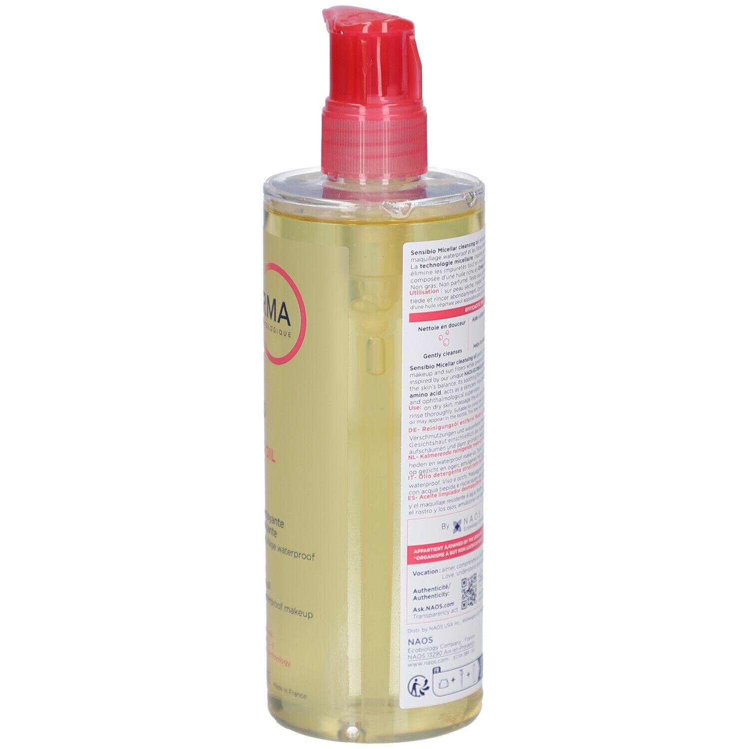 Achterkant van de fles met productinformatie. Rode pompsluiting. Transparante vloeistof.