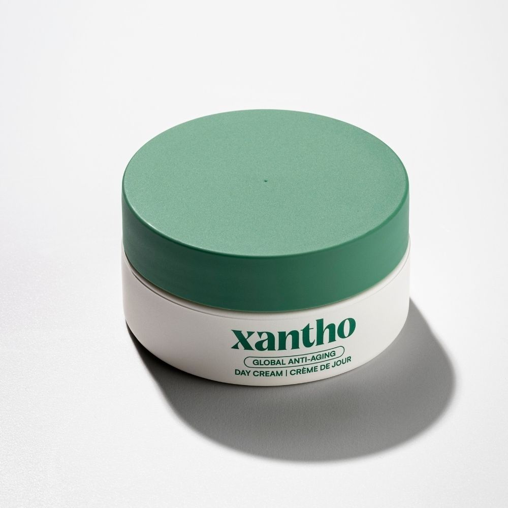 Xantho Global Anti-Aging dagcrème in witte pot met groen deksel.