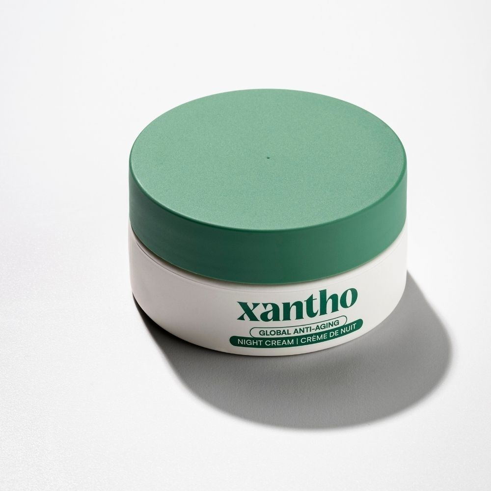 Xantho Global Anti-Aging nachtcrème in een witte pot met groene dop.