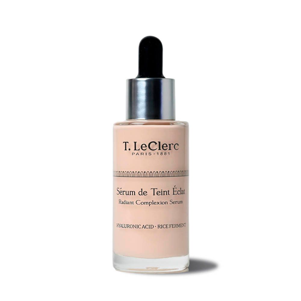 T.LeClerc serumfles. Beige vloeistof, zilveren dop, zwarte pipet. Opschrift: Sérum de Teint Éclat, Radiant Complexion Serum.