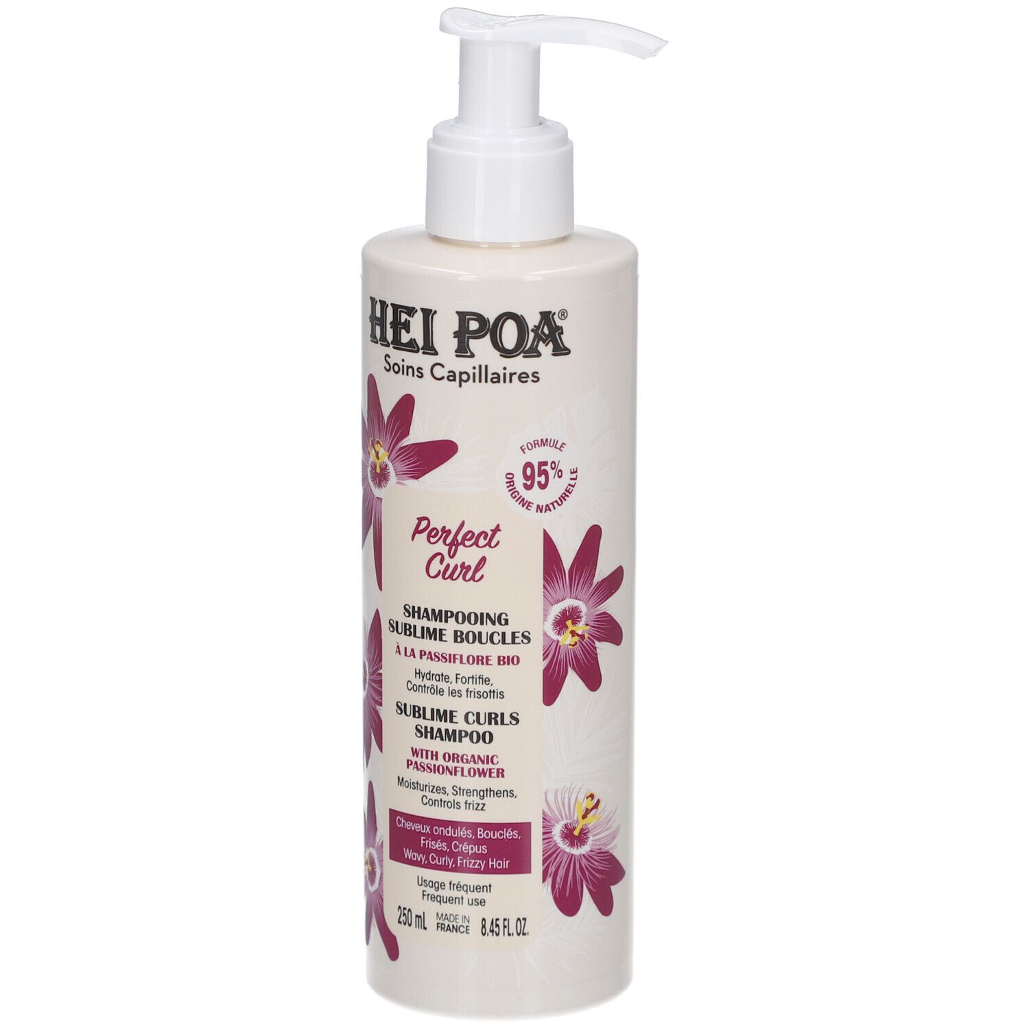 Flacon de shampooing avec pompe. Inscriptions: Hei Poa, Perfect Curl, Sublime Boucles, 250ml. Décoré de fleurs violettes.