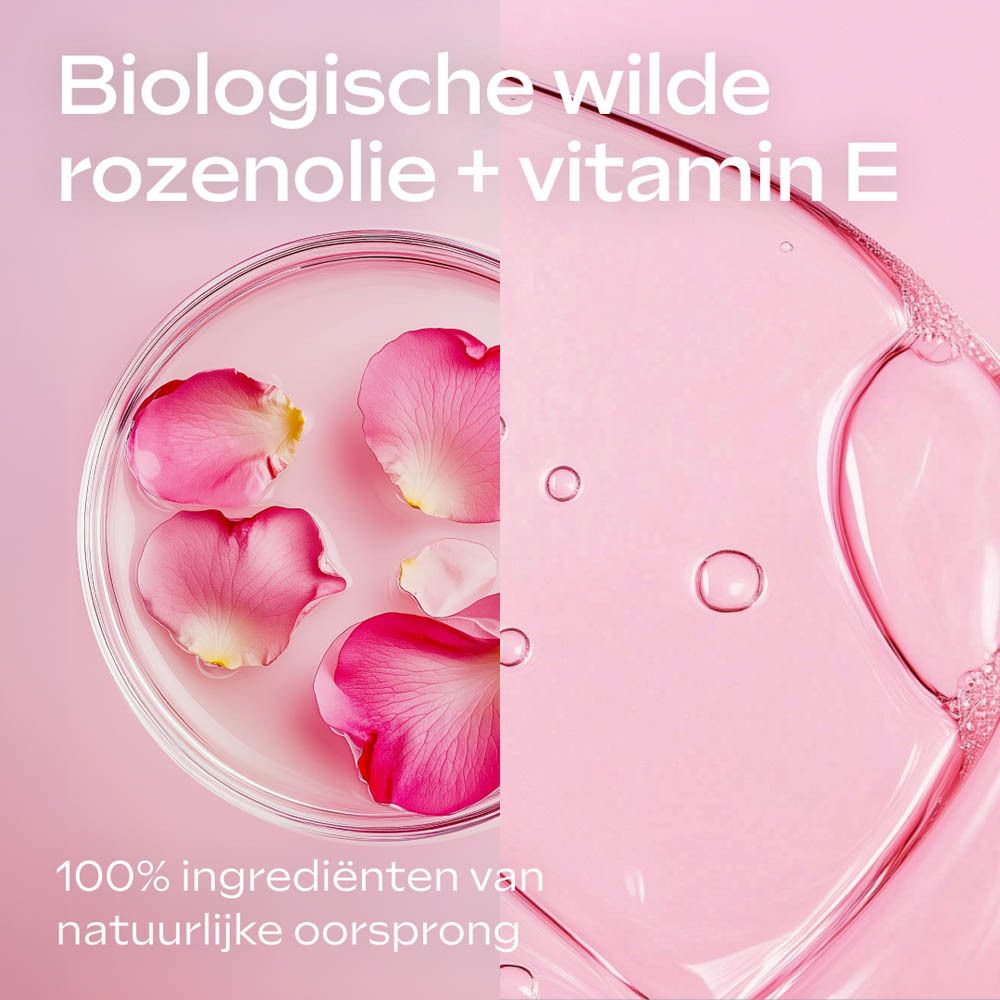 Close-up van rozenblaadjes en vloeistof. Tekst: Biologische wilde rozenolie + vitamine E.