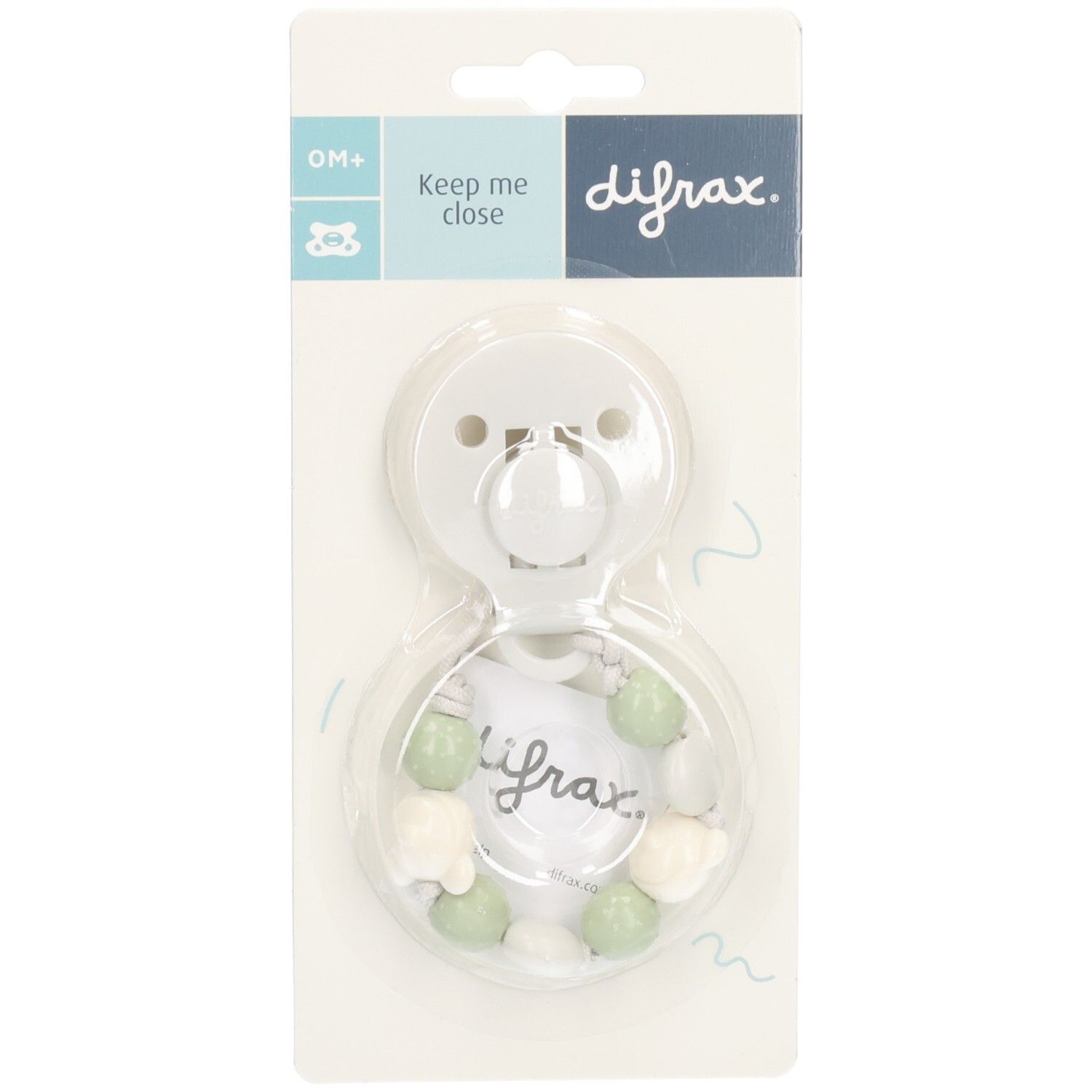 Witte speen met groene en witte kralen in blisterverpakking. Merk: Difrax. Opschrift: Keep me close.
