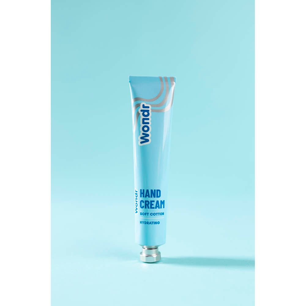 Lichtblauwe tube met zilveren dop. Opschrift: Wondr, Hand Cream, Soft Cotton, Hydrating.