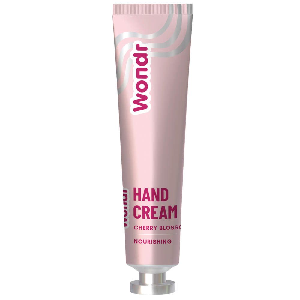 Tube rose avec vagues argentées et logo "Wondr". "Hand Cream Cherry Blossom" et "Nourishing" imprimés.